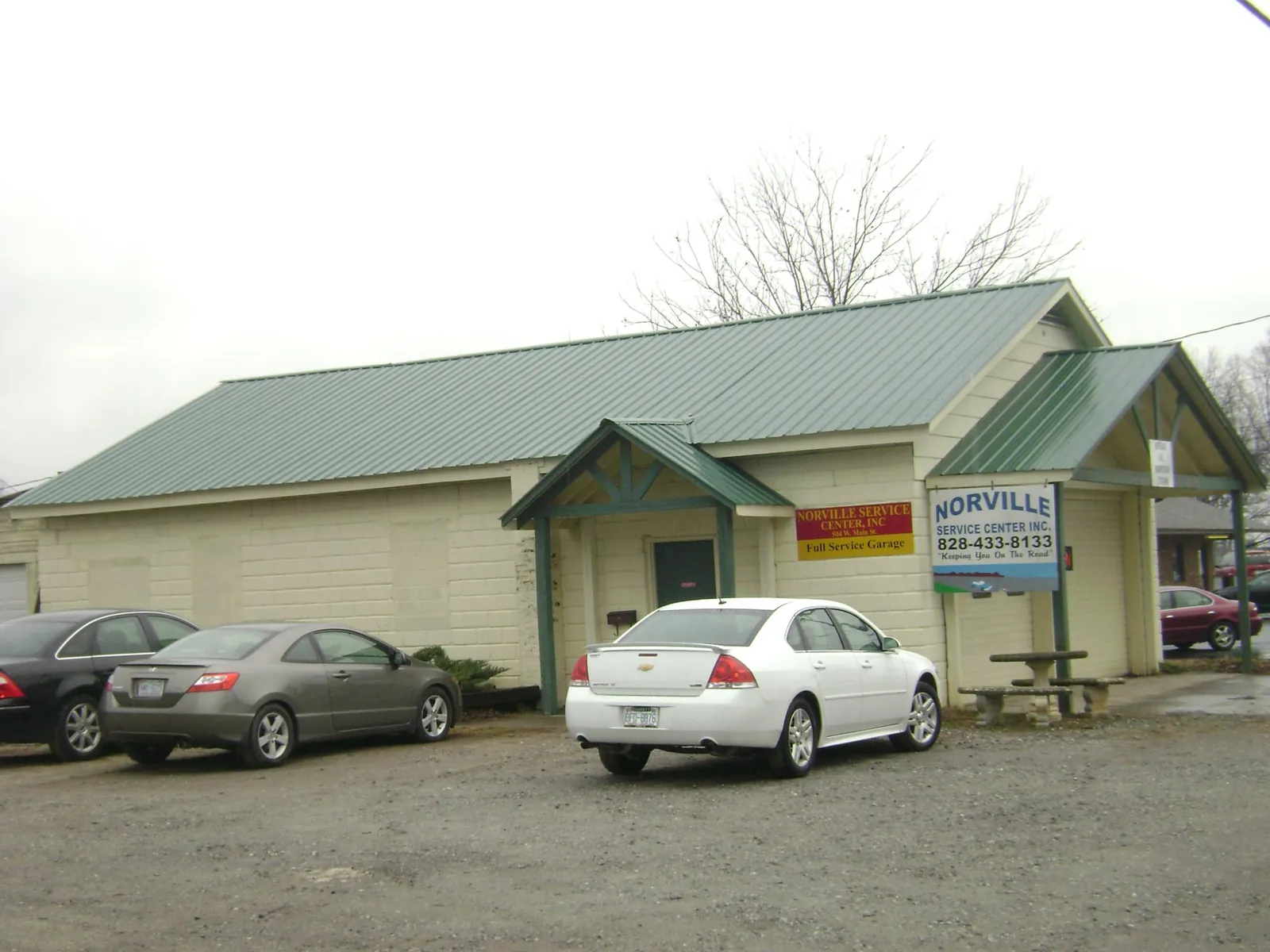 Green metal roof on a service garage with a covered entry in Tewksbury
